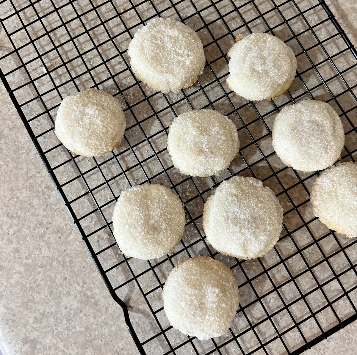 cooling rack filled with sugar dusted cookies