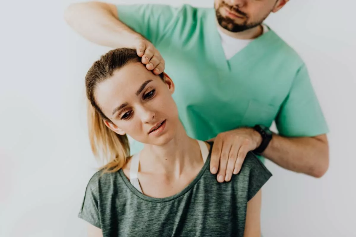 doctor treating a woman with a neck injury