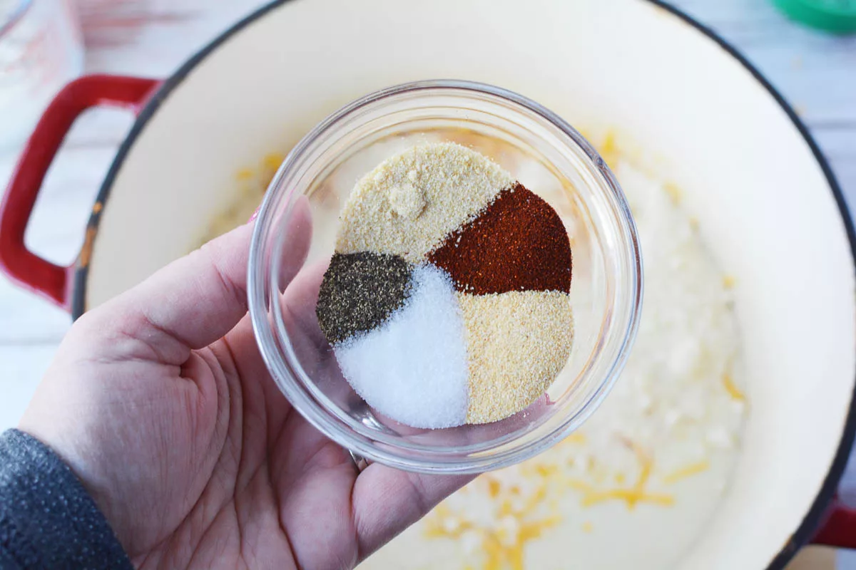 Adding the spices to the mac and cheese 