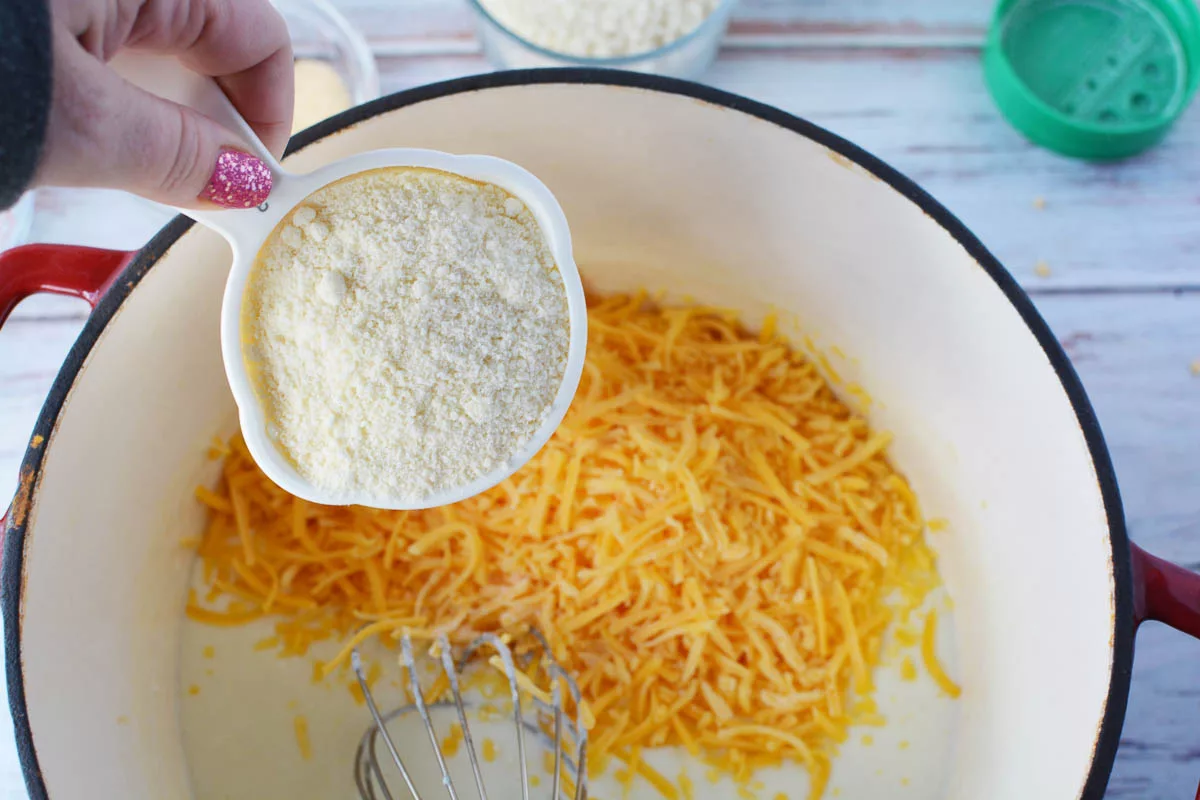 Adding parmesan cheese to the Dutch oven 