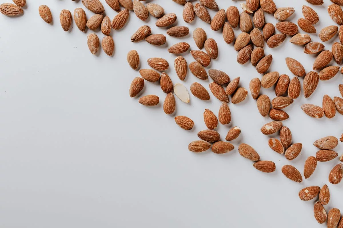 scattered almonds on a white background