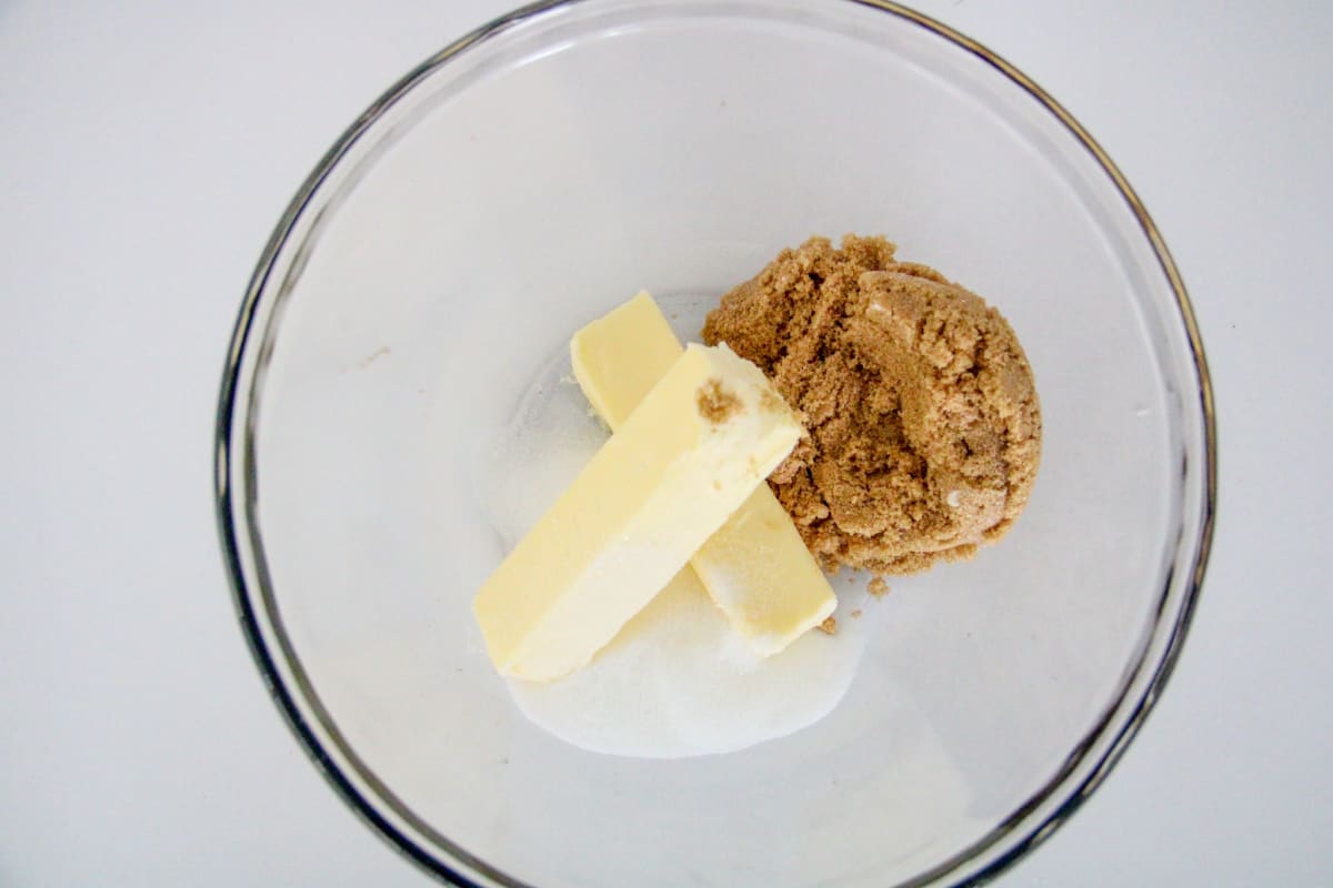 Overhead shot of butter and sugars in mixing bowl. 