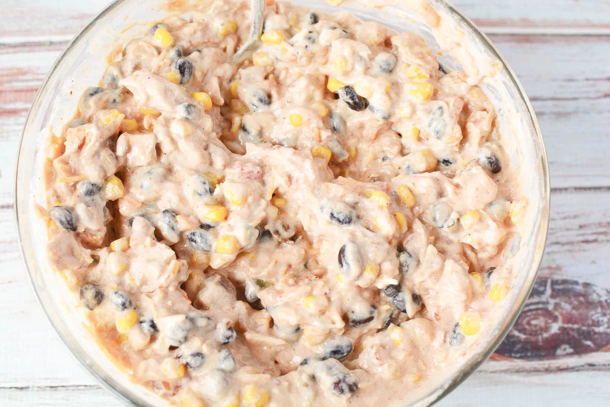 bowl of sour cream, salsa, black beans and corn mixed up