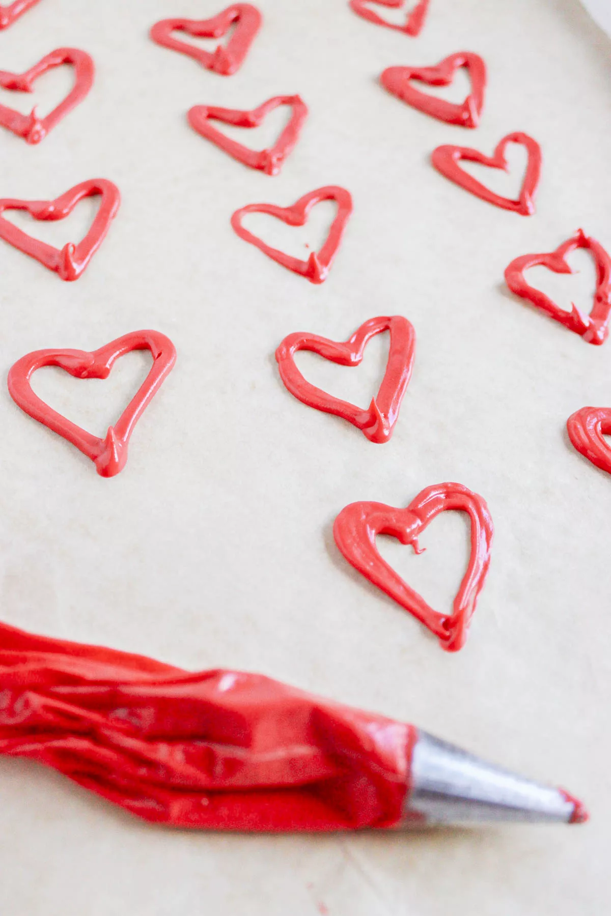 Red Chocolate hearts on a piece of parchment paper 