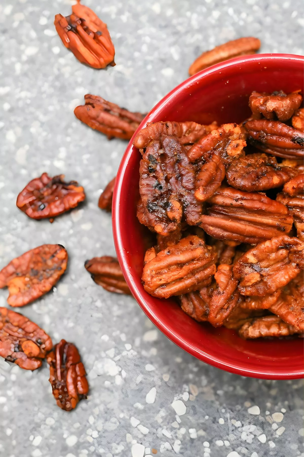 Sweet and Sriracha Spiced Pecans in a red bowl