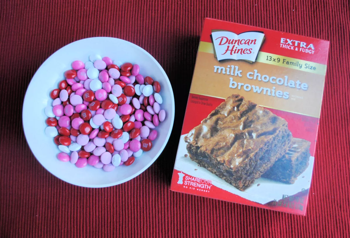 box of duncan hines milk chocolate brownie mix and a bowl of red and pink Valentine M&M candies