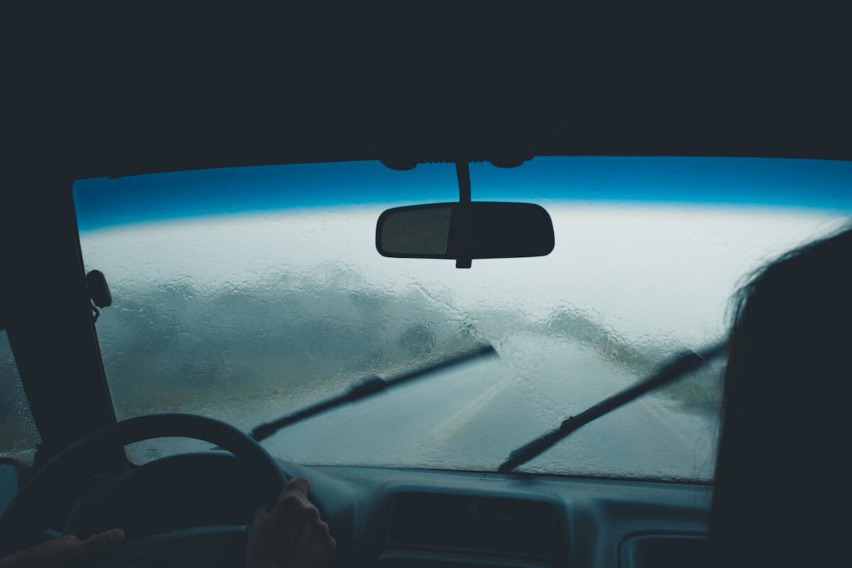 rainy windshield in a car on road trip