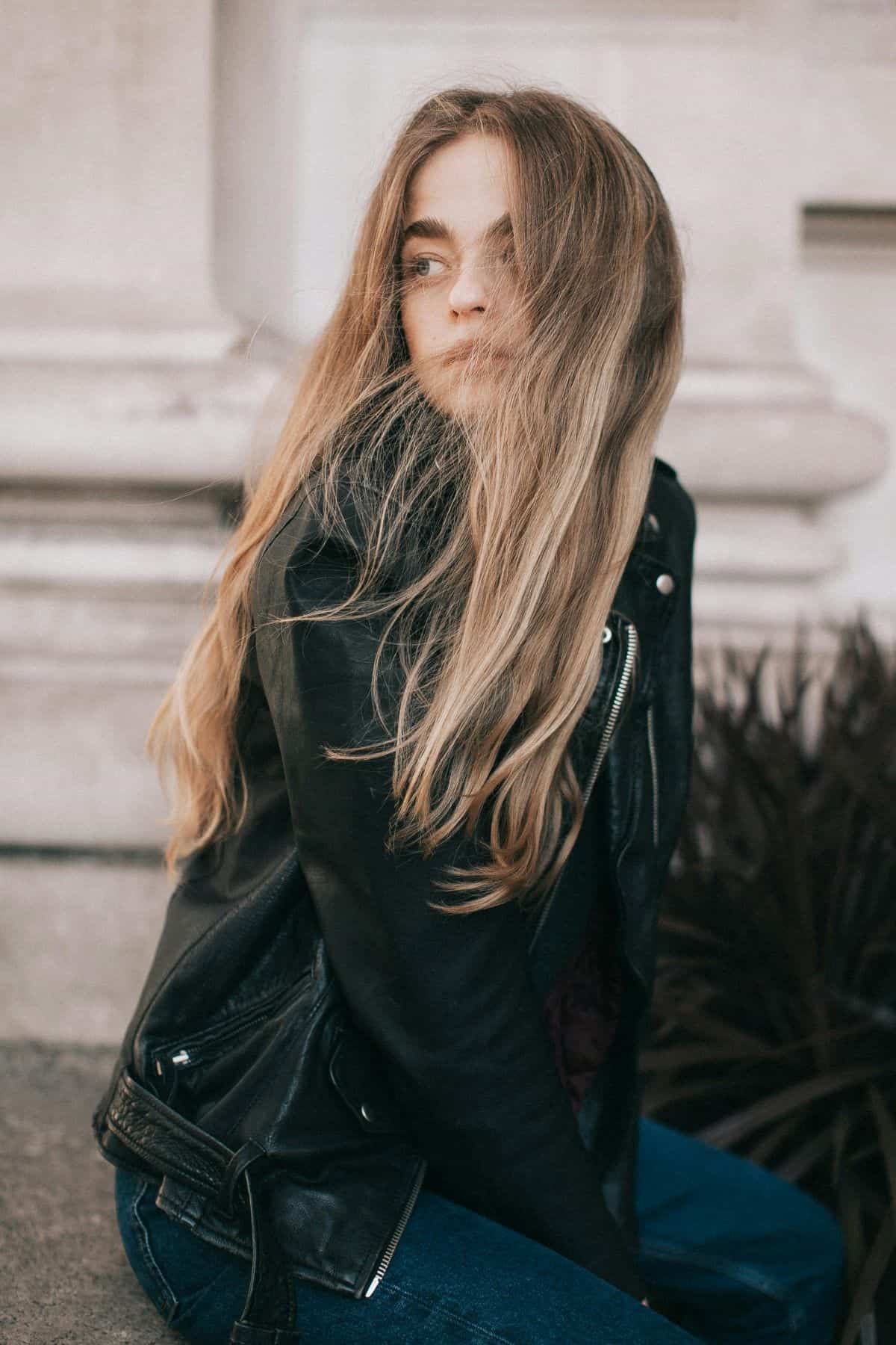 woman in a black leather jacket with long hair