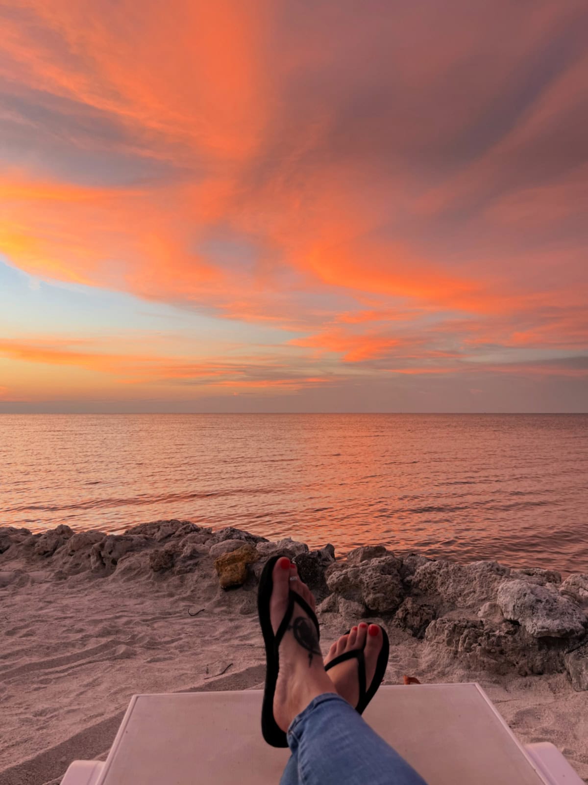 toes on the beach at sunset in the florida keys