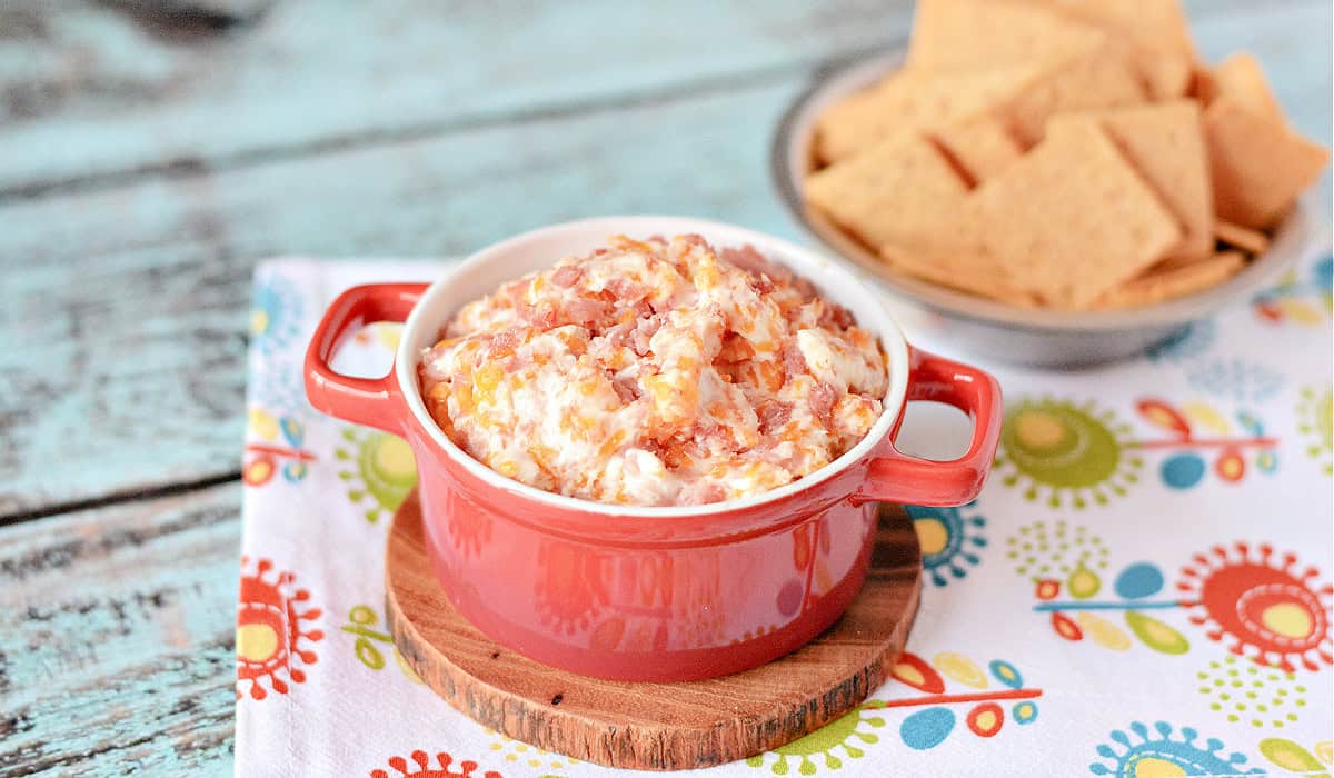 Hot Ham and Cheese Dip in a red bowl with crackers