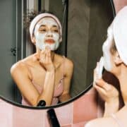 woman putting on a facial mask for her dry skin
