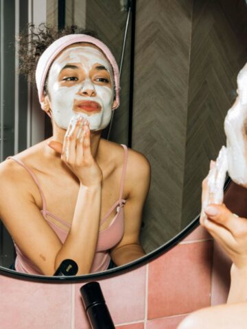 woman putting on a facial mask for her dry skin