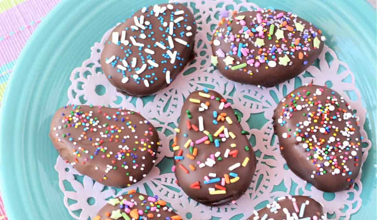 Chocolate Peanut Butter Eggs with sprinkles on top on a blue plate