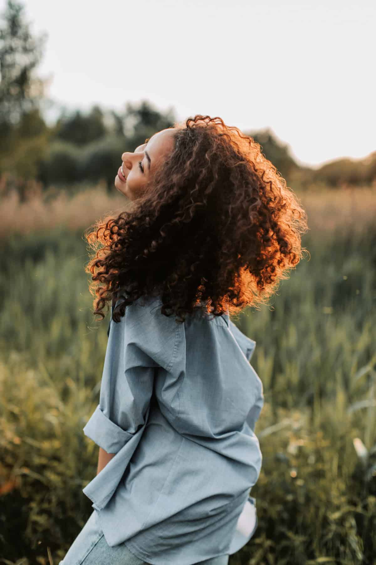 woman basking in the sunshine looking happy