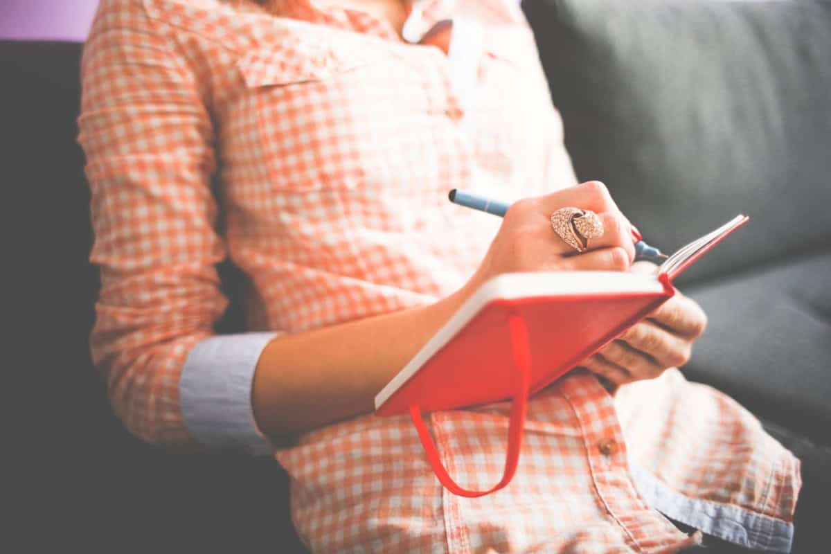 woman holding a journal on her lap