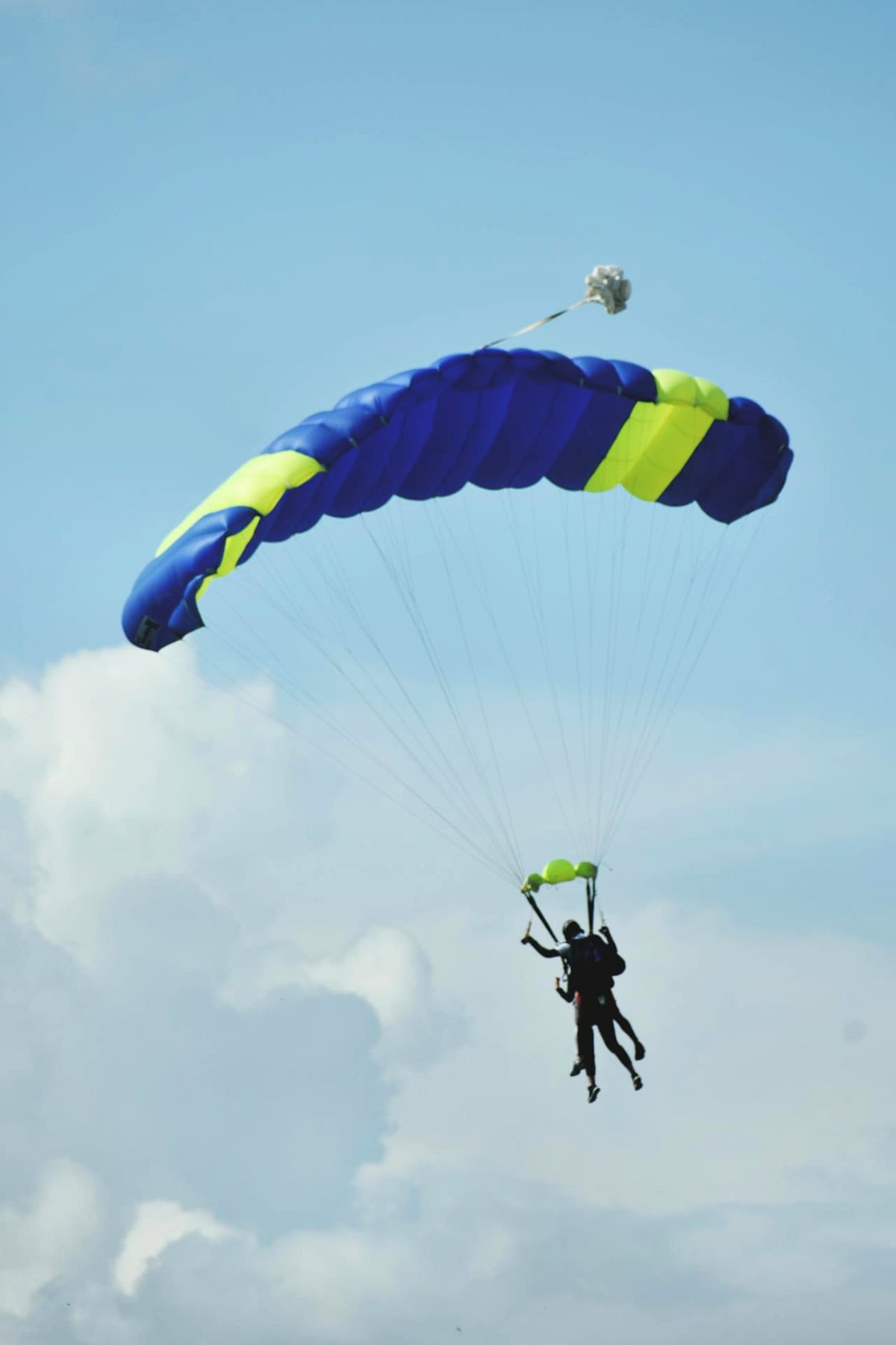 people skydiving against a blue sky