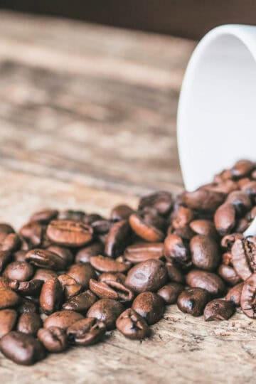 coffee beans in a white coffee mug
