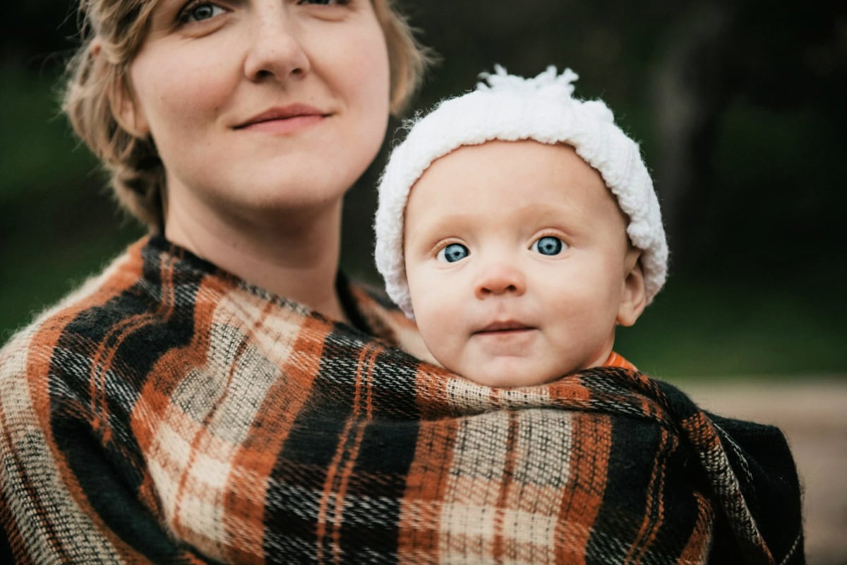 baby in a plaid sling
