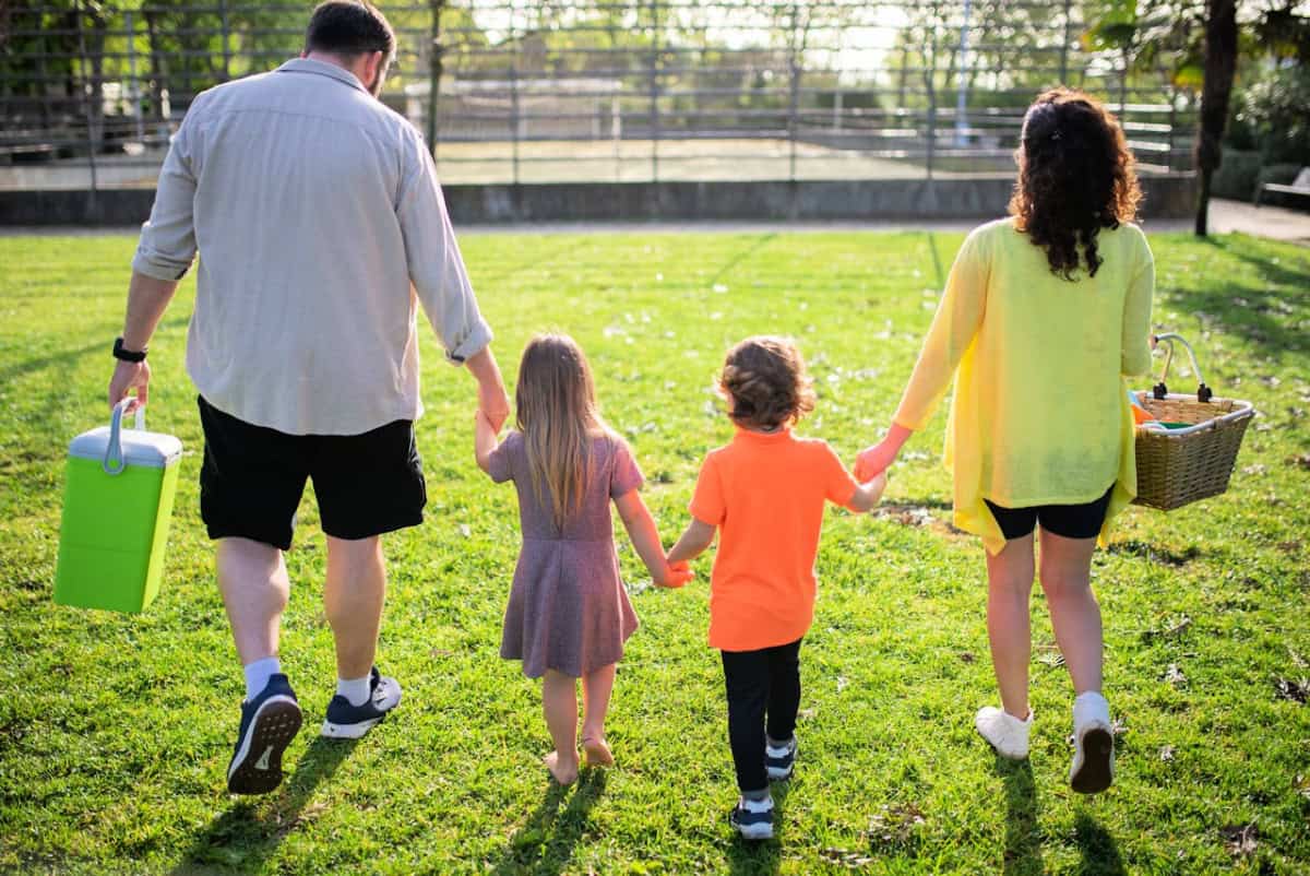 family in the park with a cooler