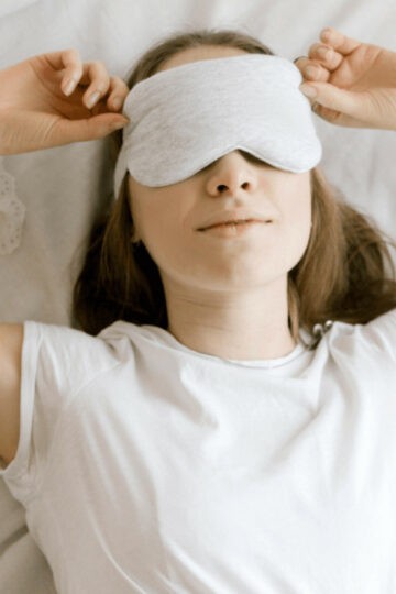 woman relaxing with an eye mask on her eyes