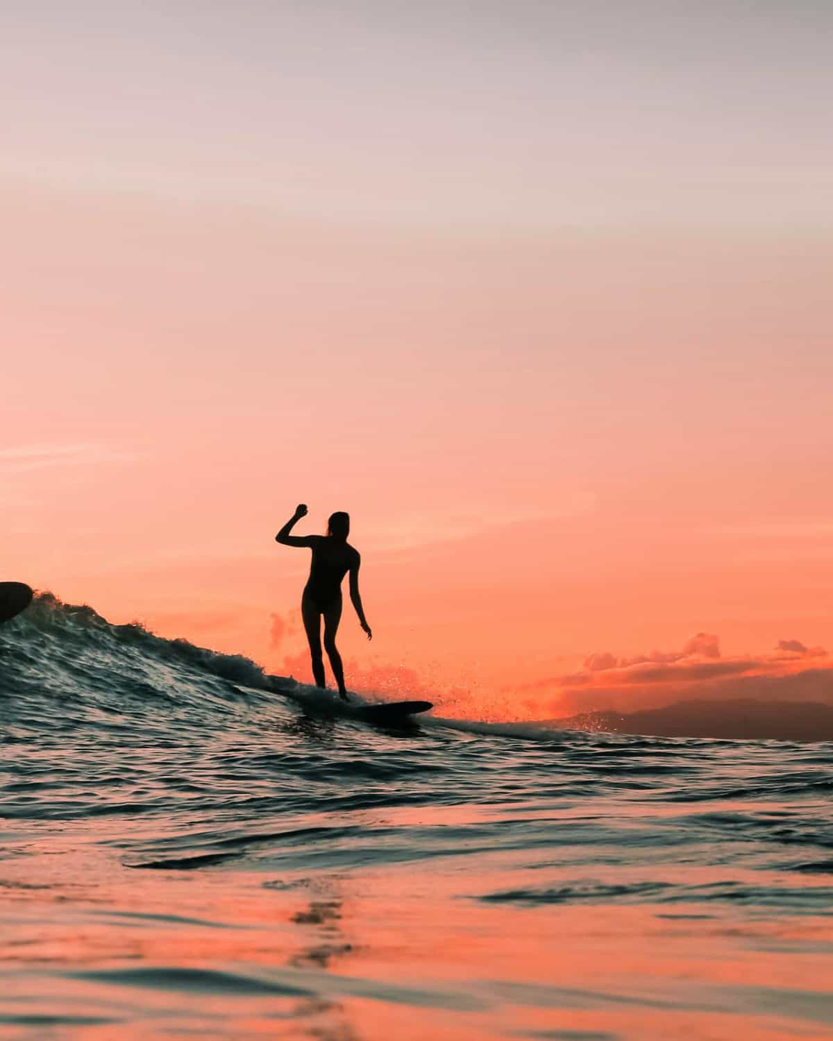 person surfing at sunset