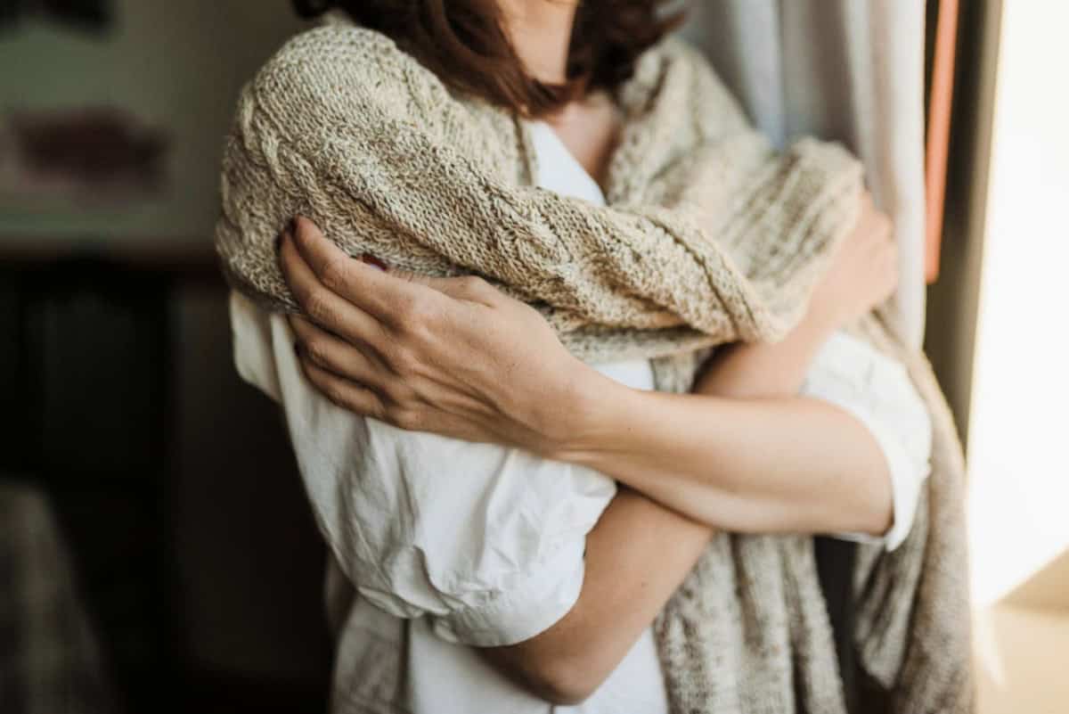 woman wearing linen shirt with a chunky sweater