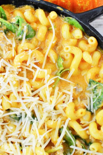 Creamy Italian Sausage Pasta with Pumpkin and spinach topped with parmesan cheese