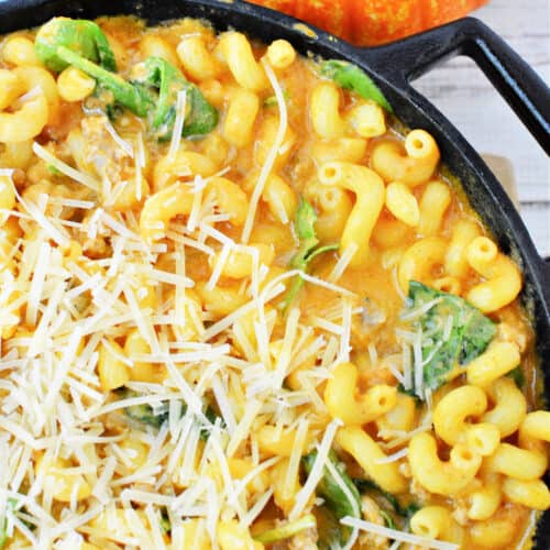 Creamy Italian Sausage Pasta with Pumpkin and spinach topped with parmesan cheese