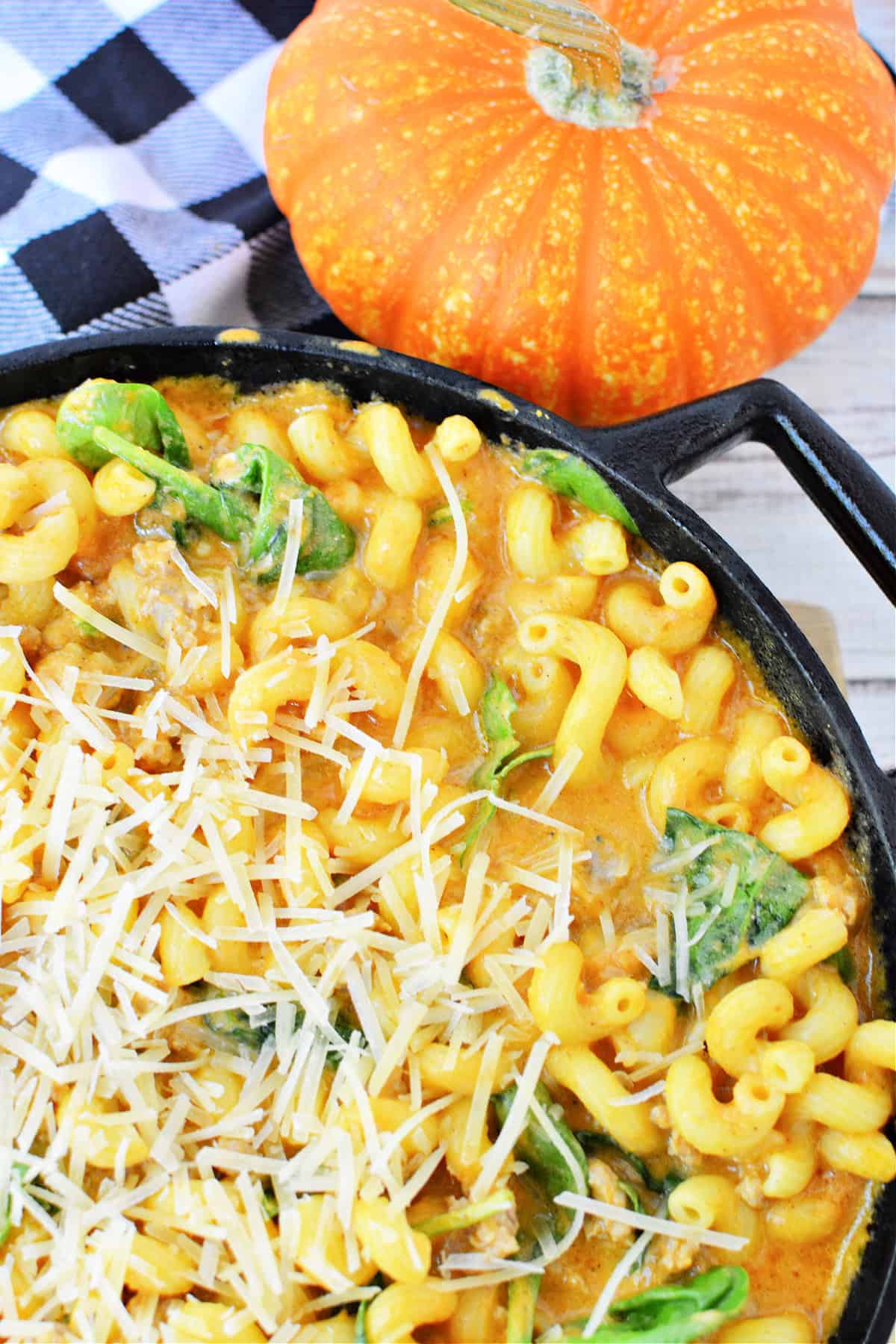 Creamy Italian Sausage Pasta with Pumpkin and spinach topped with parmesan cheese