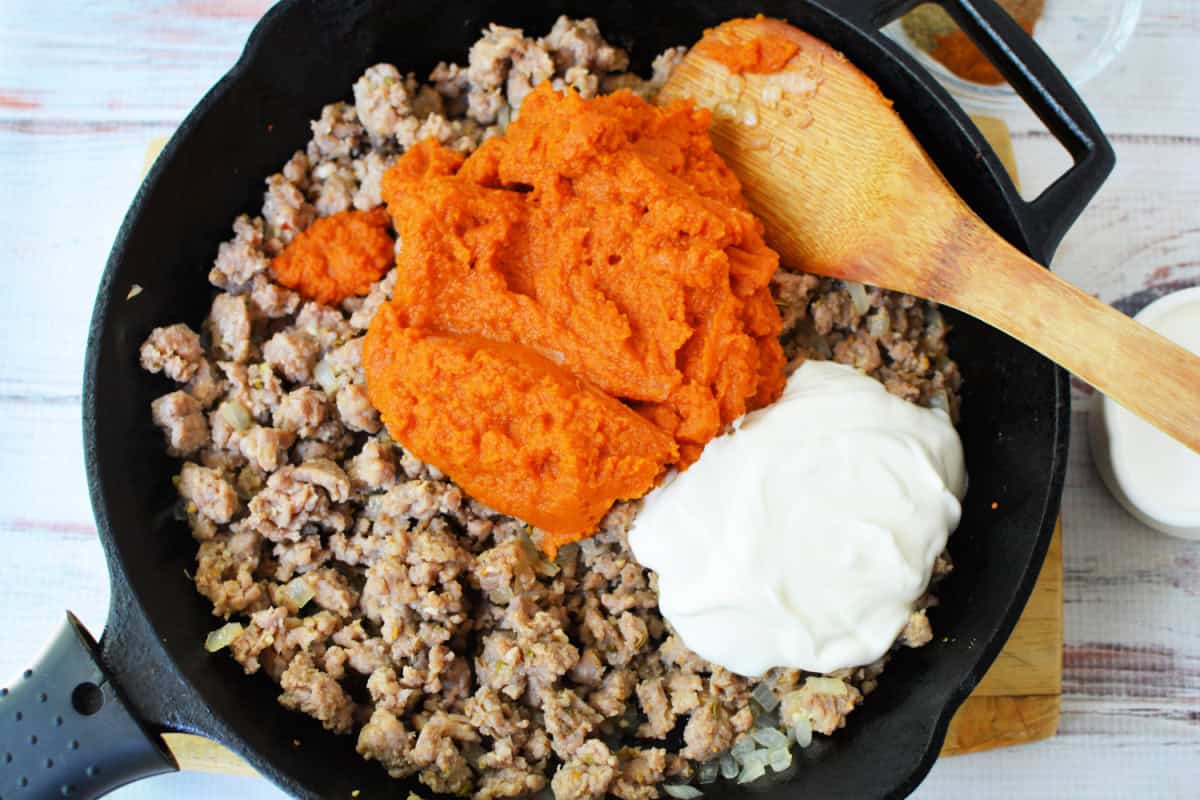 ground beef browned in a skillet with pumpkin puree and sour cream