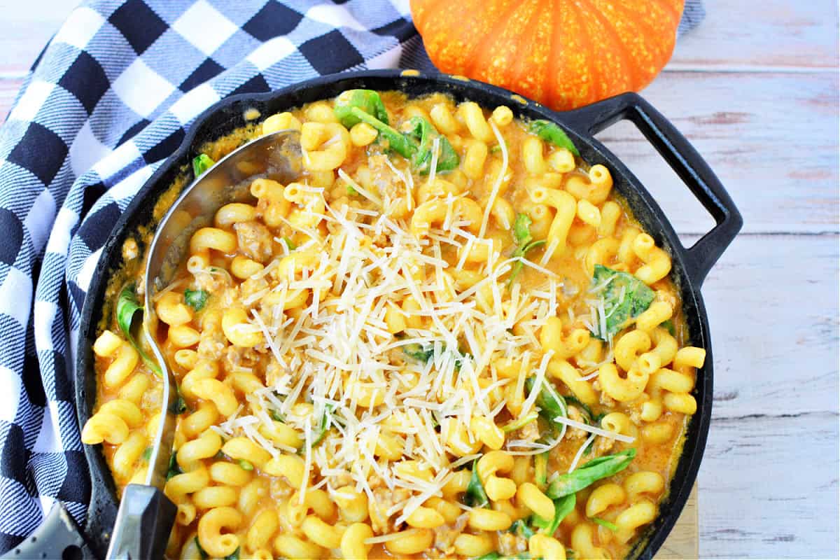 Creamy Italian Sausage Pasta with Pumpkin and spinach topped with parmesan cheese
