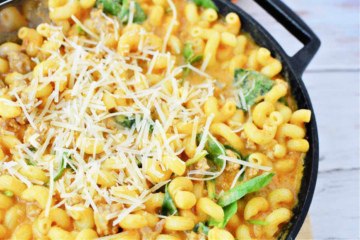 Creamy Italian Sausage Pasta with Pumpkin and spinach topped with parmesan cheese
