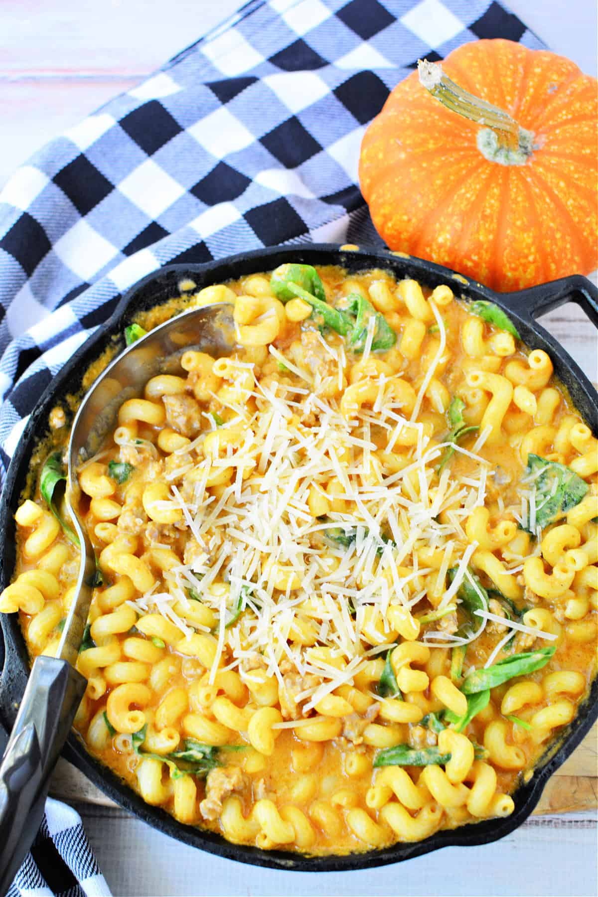 Creamy Italian Sausage Pasta with Pumpkin and spinach topped with parmesan cheese