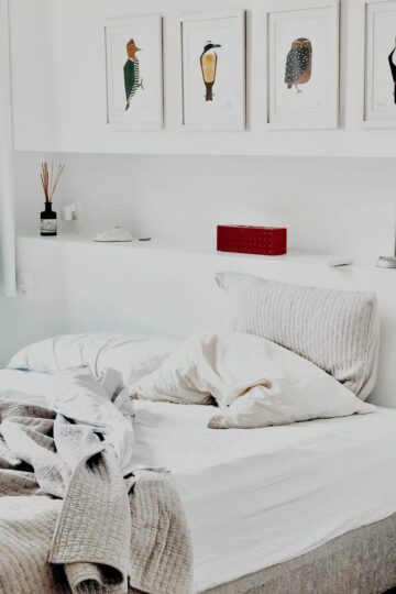 white bedroom with white bed and white bed linens for better sleep