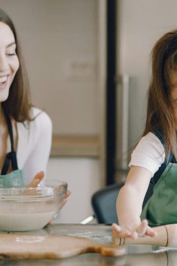 grandma and grandchild baking in the kitchen