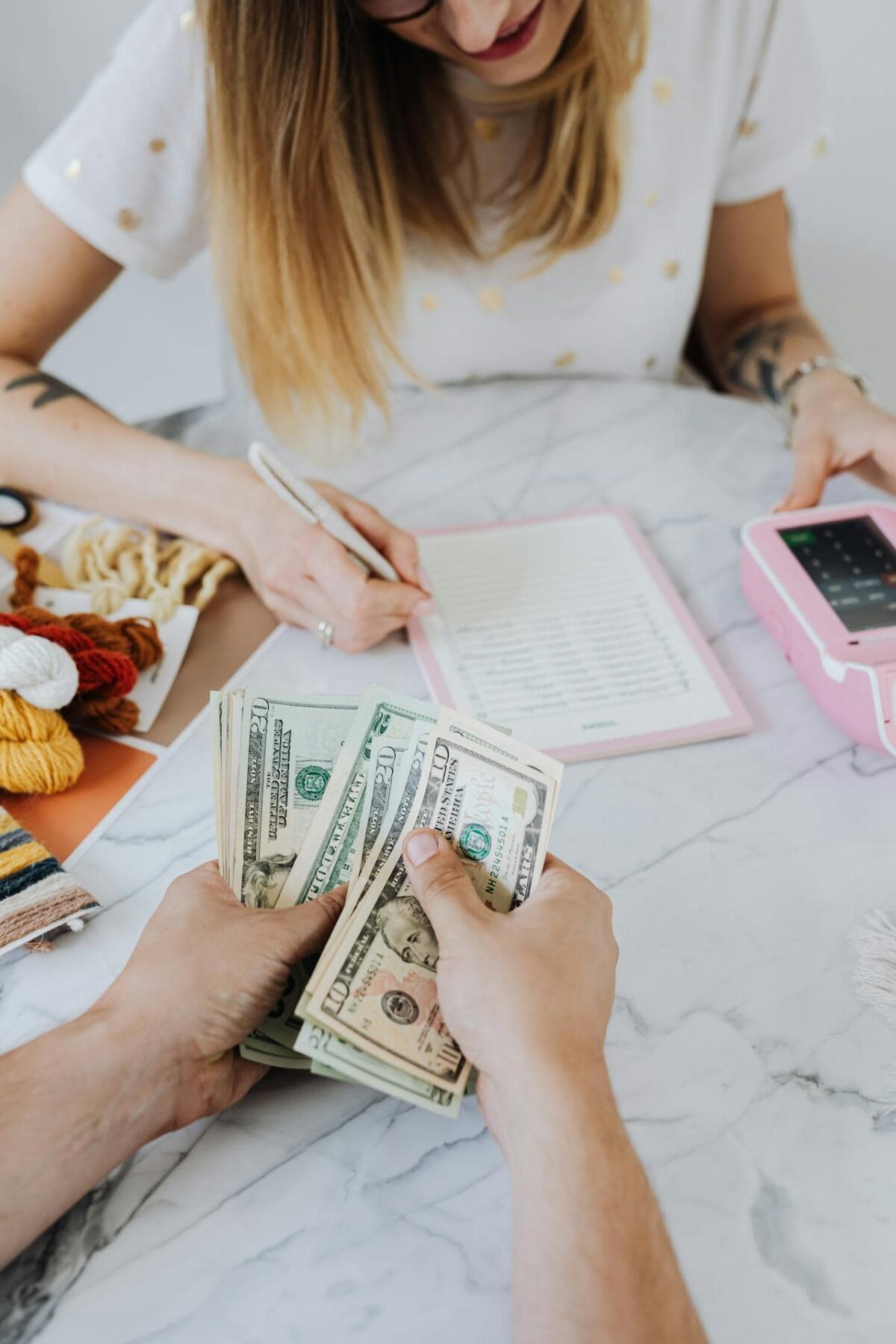 woman going over budget with cash in hand