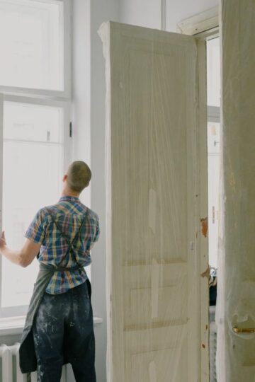 man installing new windows in home