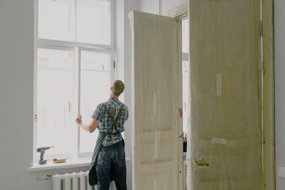 man installing new windows in home