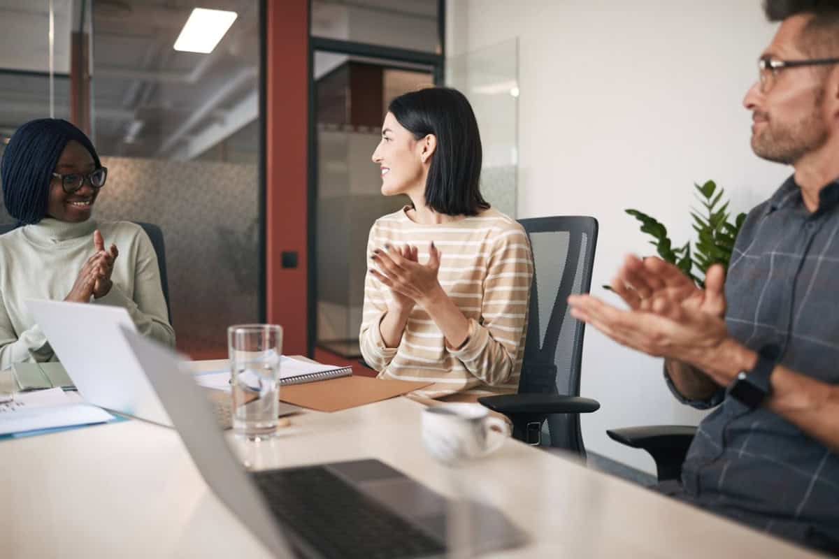 employees at a conference table at work