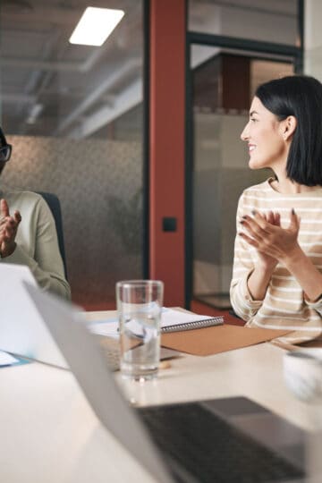 employees at a conference table at work