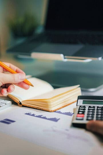 calculator and notepad with a pencil for budgets