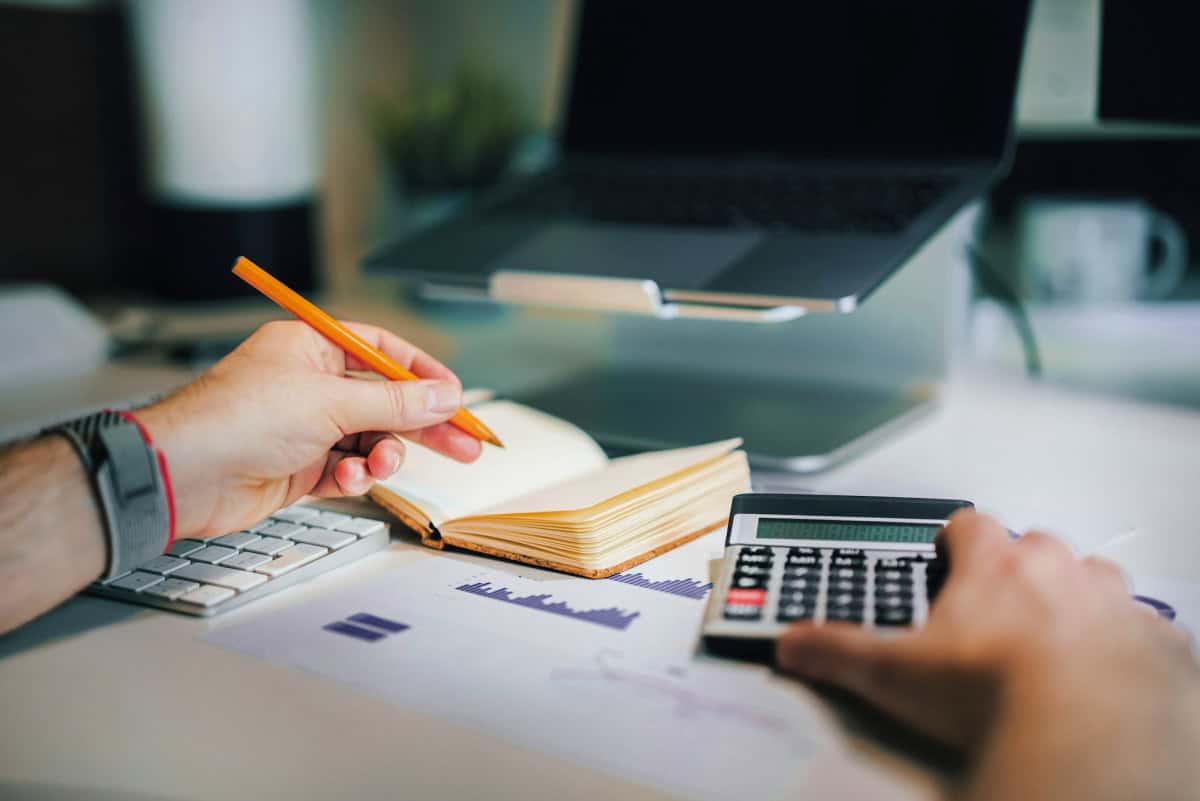 calculator and notepad with a pencil for budgets