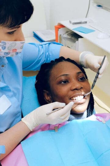 child getting their teeth cleaned by a dentist