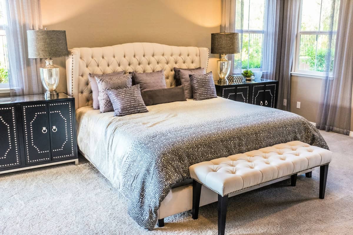 elegant bedroom with bedding and lamps