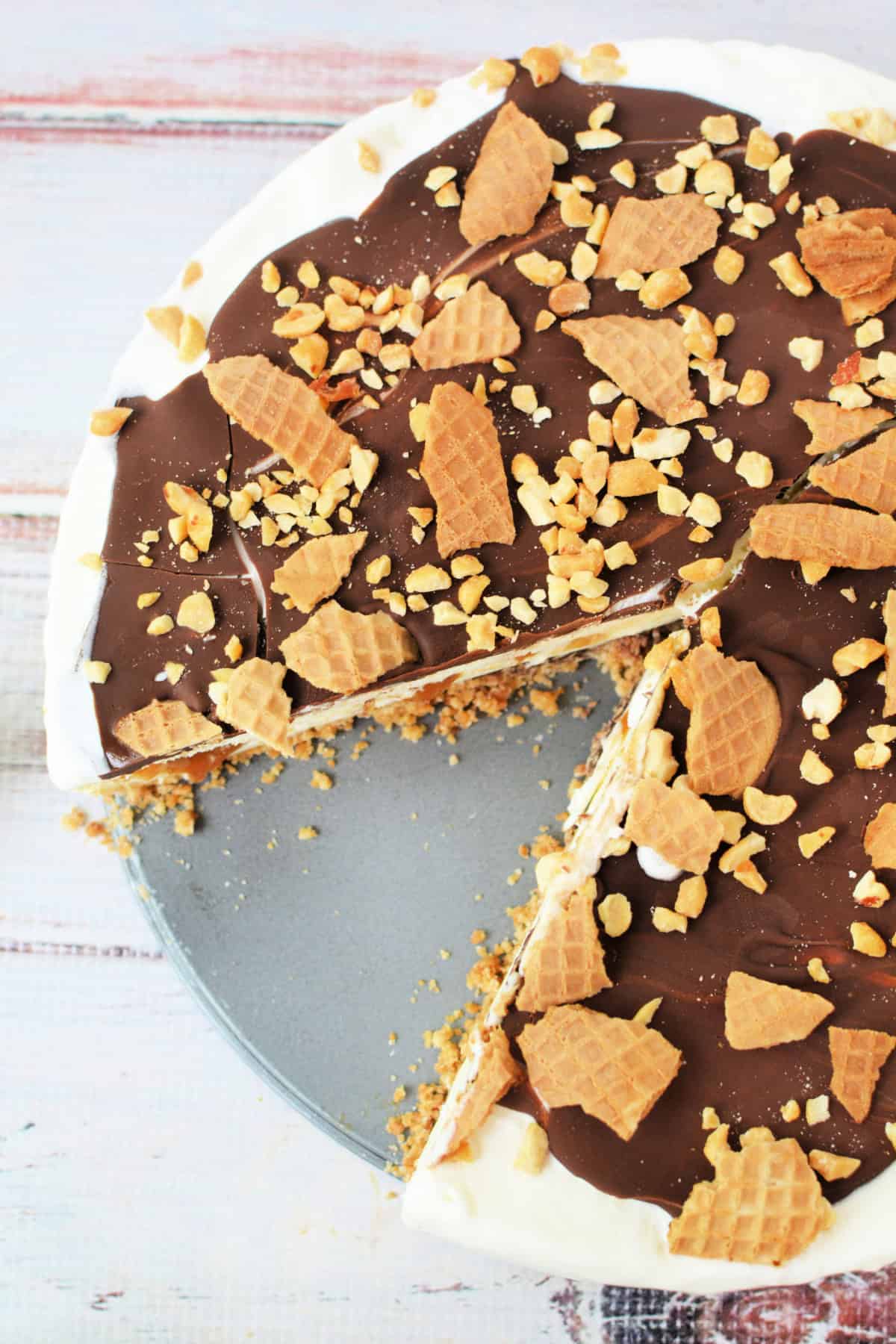 Close up shot of a Drumstick Ice Cream Cake with a slice cut out